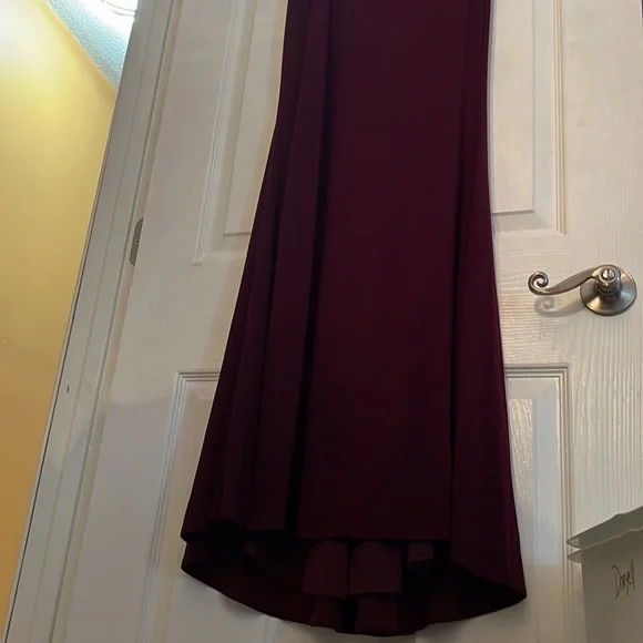 This prom dress is Burgundy, a size 2 with corset straps in the back. Worn once